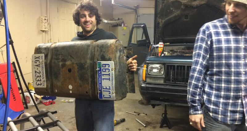 Philip holds the gas tank skid plate. He’s proud of his rust-hole patch job.